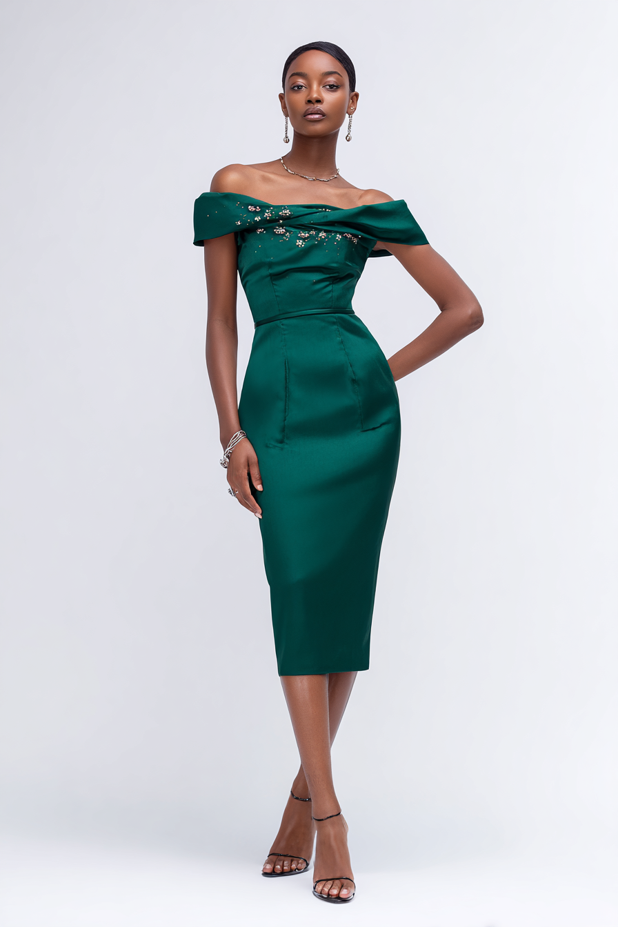 A sophisticated emerald green fitted dress with a classic silhouette, featuring an off-shoulder neckline and subtle embellishments, styled with metallic accessories and chic heels. The model with tan skin poses against a clean white background, illuminated perfectly to convey timeless elegance --ar 2:3 --v 7 --style raw