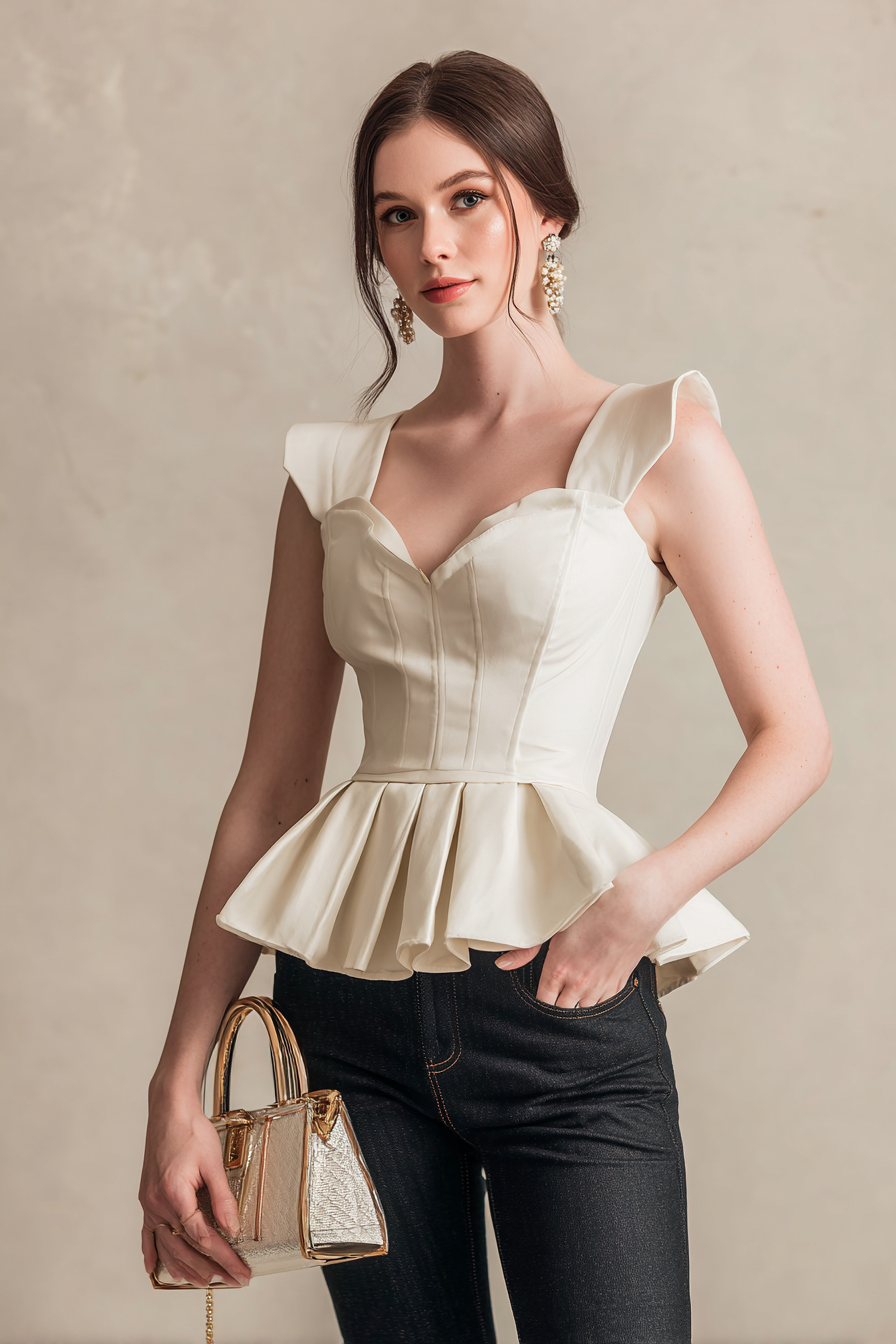 A full-body image of a woman wearing a fitted white peplum top combined with high-waisted dark denim jeans, accessorized with a chic handbag and elegant statement earrings, set against a neutral backdrop with a subtle bokeh effect. The model has an ivory skin tone, creating an effortlessly classy vibe in professional studio light --ar 2:3 --v 7 --style raw